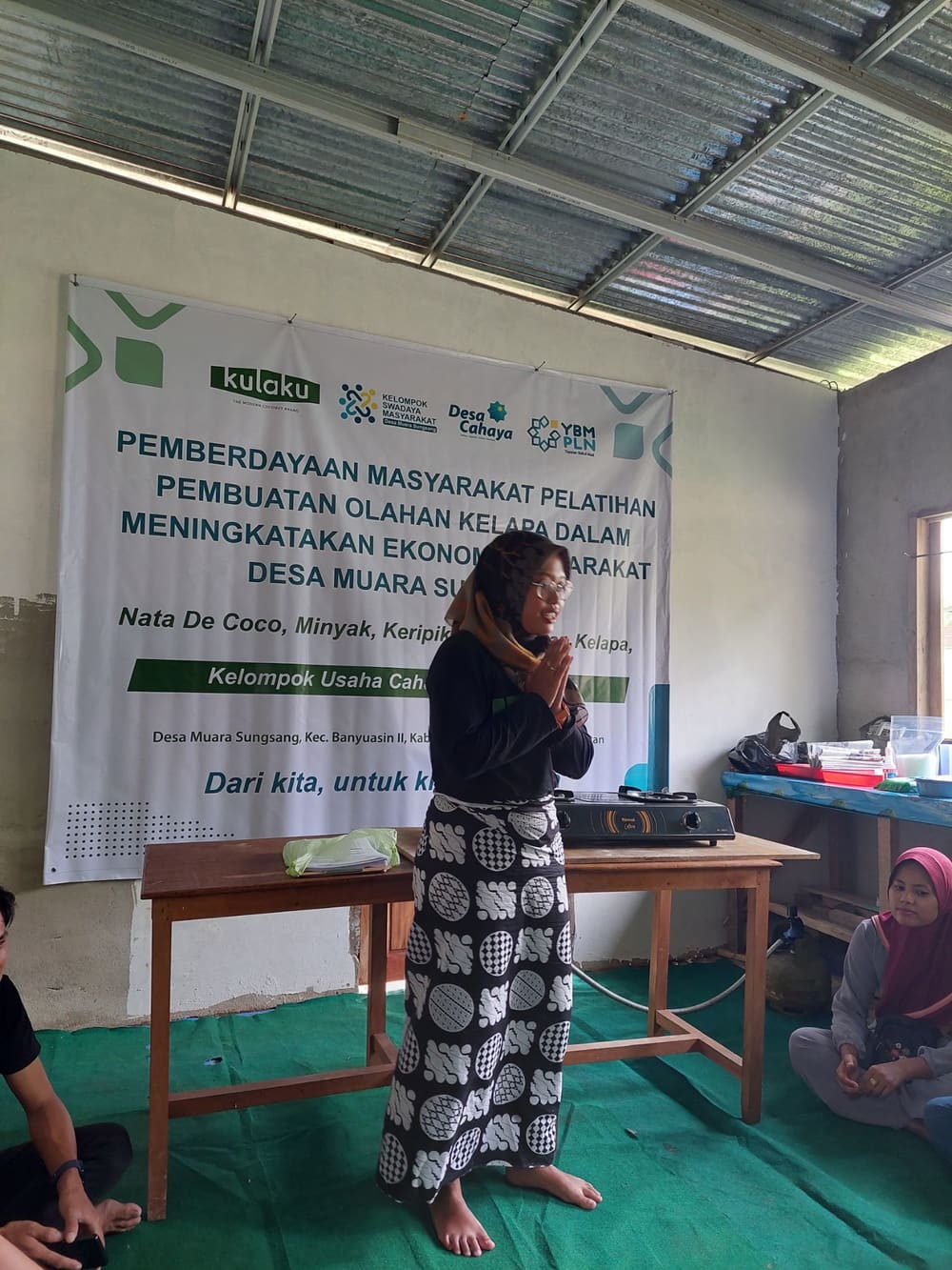 Gita opening a coconut-processing training in Muara Sungsang Village