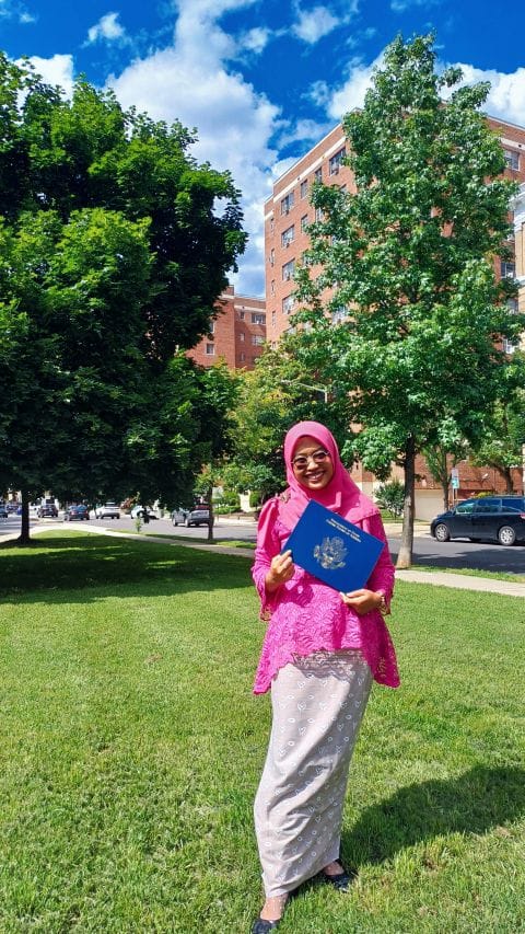 Gita smiling and holding her YSEALI Professional Fellows certificate